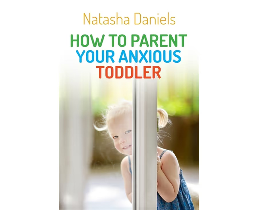 Book cover of 'How to Parent Your Anxious Toddler' by Natasha Daniels, featuring a young blonde girl peeking playfully from behind a door, with bright, colorful title text on a soft-focus background.